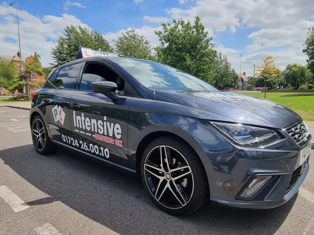 Advanced driving lessons by Intensive Driving UK in a modern car with the company logo visible.
